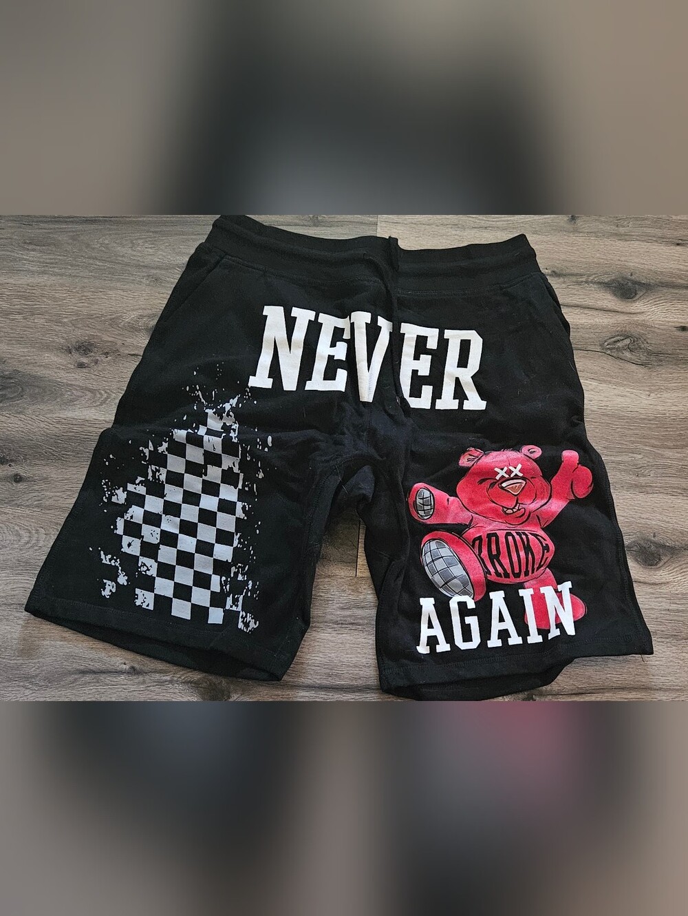 Black 'Never Again' Graphic Men's Shorts with Red Bear Accent